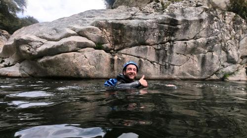 Hiker swims in the water of Bau Mela