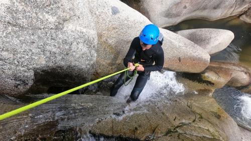 Boy plunges into water while canyoning in Bau Mela