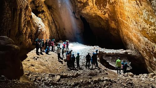 Escursionisti all'interno della grotta Sa Nurre de Su Hoda a Oliena