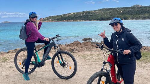 Two girls smile during electric bike tour in Costa Smeralda