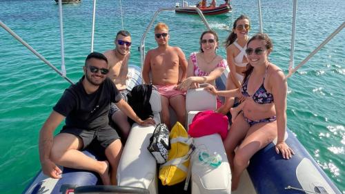 People have fun aboard the dinghy in Cagliari