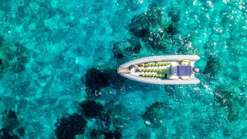Maxi dinghy stops among the crystal clear waters of La Maddalena Archipelago