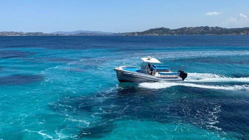 Maxi dinghy sails through the crystal clear waters of La Maddalena Archipelago