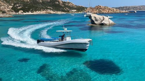 Maxi dinghy  sails the waters of Cala Corsara in Spargi