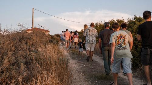 I partecipanti camminano nel vigneto di una cantina a Castelsardo