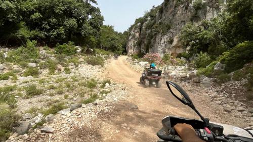 Quads travel along a dirt road in the Golgo plateau