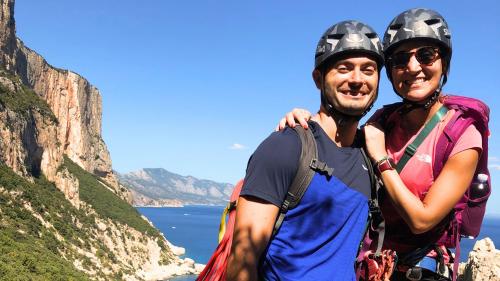 Couple with equipment during a rope descent in the Gulf of Orosei