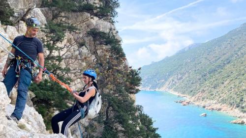 Boy during abseiling with guide and equipment