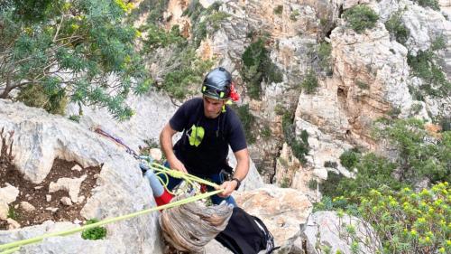 Boy descends from the mountain to the sea via a guided rope descent