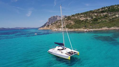 Catamaran in the crystal-clear waters of the Tavolara marine protected area