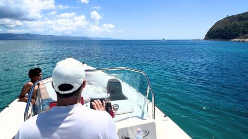 The Devil's Saddle in the background as the dinghy sails into the crystal clear sea