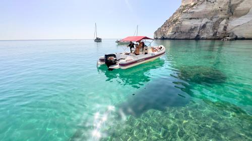 Dinghy in the crystal-clear waters of the Gulf of Cagliari