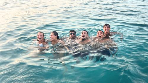 Young youths swimming in the waters of the Gulf of Angels