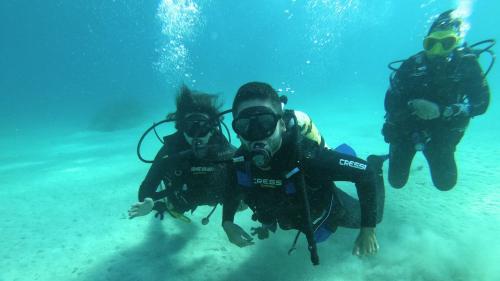 People diving in the crystal-clear waters of southern Sardinia