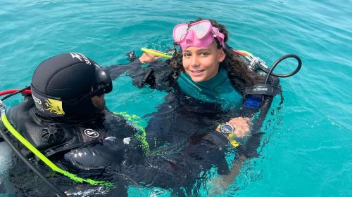 Girl ready for scuba diving in the waters of the Gulf of Cagliari