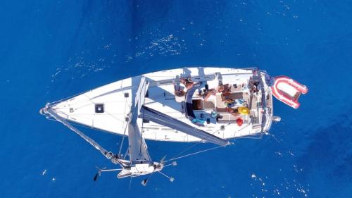 Top view of the sailboat while sailing in the sea of north-eastern Sardinia