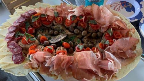 Chopping board with local products served during lunch while sailing in the waters of La Maddalena