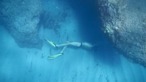 Person snorkeling in the crystal-clear waters of the Gulf of Orosei