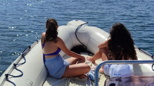 Two girls relax in the bow of the dinghy