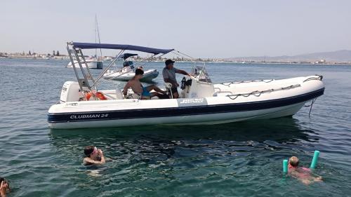 Inflatable boat stops in a cove near Cagliari