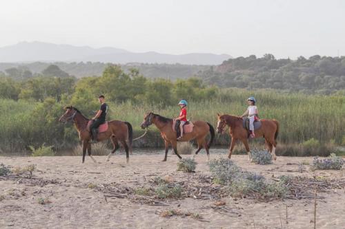 Group of people on horseback during a hike in Orosei