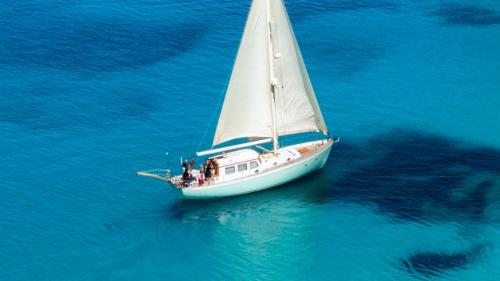 Vintage sailing ship stops among the azure waters of the northeast coast of Sardinia