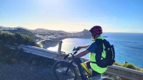 Hiker during guided ebike experience with panorama of Castelsardo