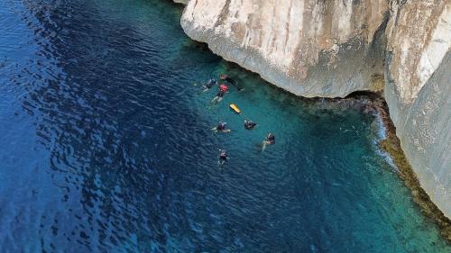 People snorkeling in the south face of Tavolara