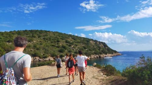 Eine Gruppe von Menschen auf dem Weg zur Cala Moresca in Golfo Aranci