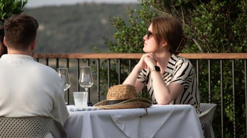 Girl enjoys the sun while sipping Vermentino wine from the winery in Palau