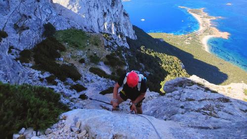 Person walking the via ferrata to the summit of Punta Cannone on Tavolara