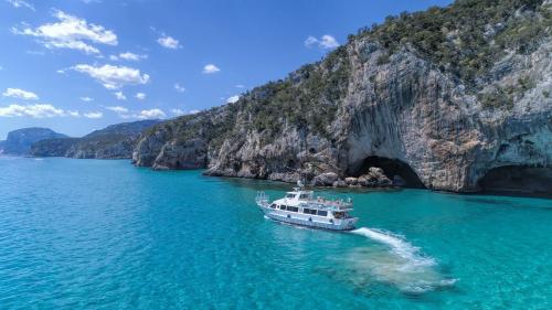 Motorboat navigates in the crystal clear waters of the Gulf of Orosei