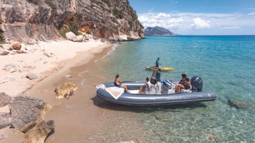 Inflatable boat stops in a cove in the Gulf of Orosei