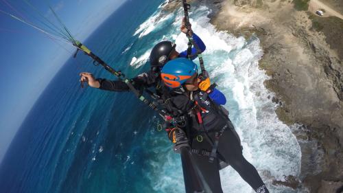 Tandem paragliding flight over the Gulf of Asinara