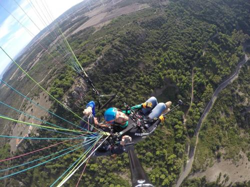 A boy takes a photo during a paragliding flight