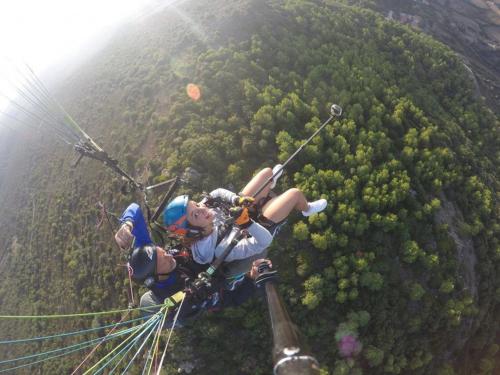 A girl performs a paragliding flight in northern Sardinia