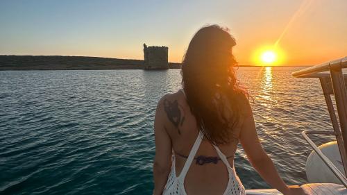 Girl watches sunset from catamaran