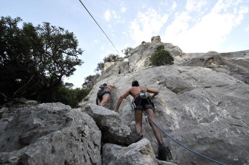 Two hikers climbing the Fuili Canyon in Dorgali