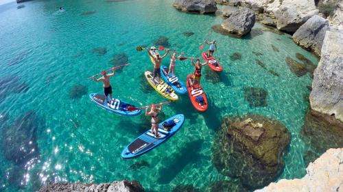 Gruppe junger Leute auf SUP in Cagliari