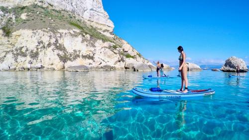 Gruppe junger Leute auf SUP in Cagliari