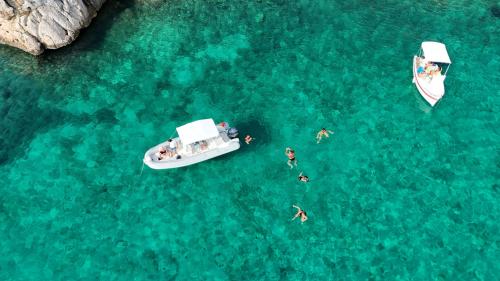 Inflatable boat in the blue water of Porto Conte Park