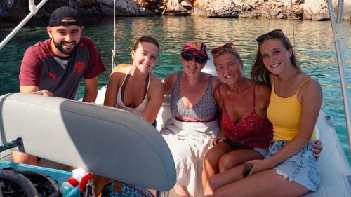 People aboard dinghy in Porto Conte Park for snorkeling experience